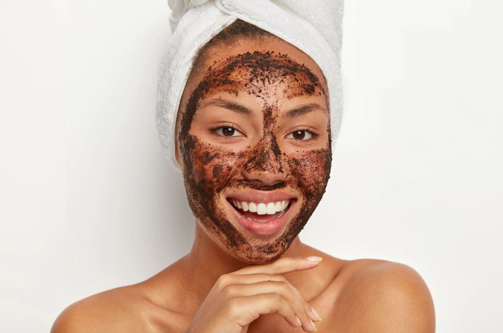 A smiling women with a brown face mask