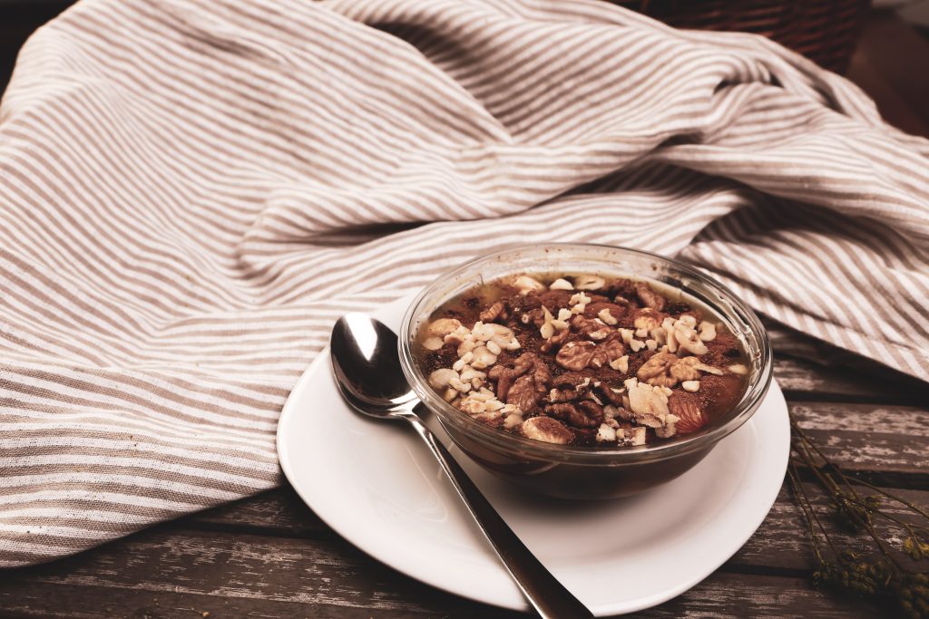 Oats in a clear bowl with a spoon