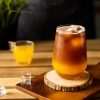 Fancy glass on a wood table with coffee and orange juice layers