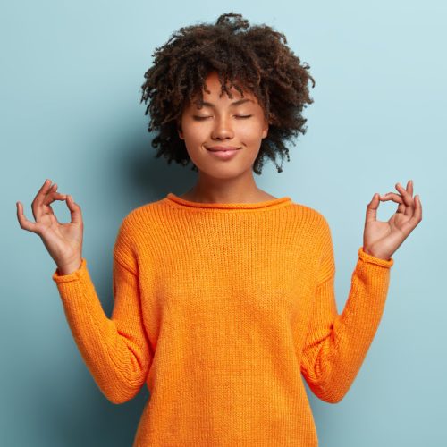 Young women practicing mindfulness with her eyes closed