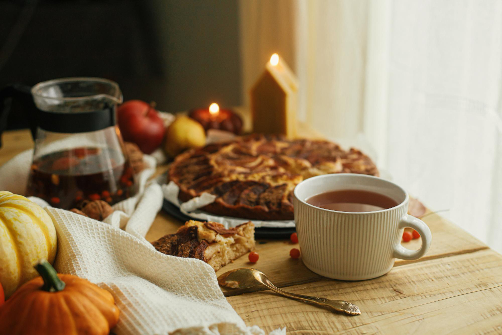 Autumn dining table with pie, gourds and a tea cup
