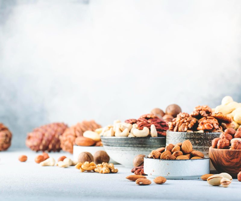 Assortment of nuts in white bowls on a table