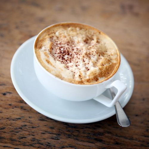 Cup of Cappuccino in a white cup on a white saucer