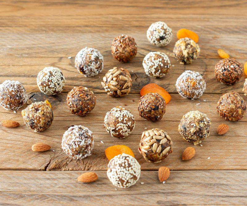 Rows of protein balls on a wood table