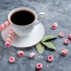 Cup of coffee hot and strong along with pink stick candies on grey, coffee candy sweet drink