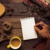 Man with a blank notebook on a table