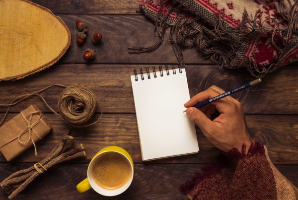 Man with a blank notebook on a table