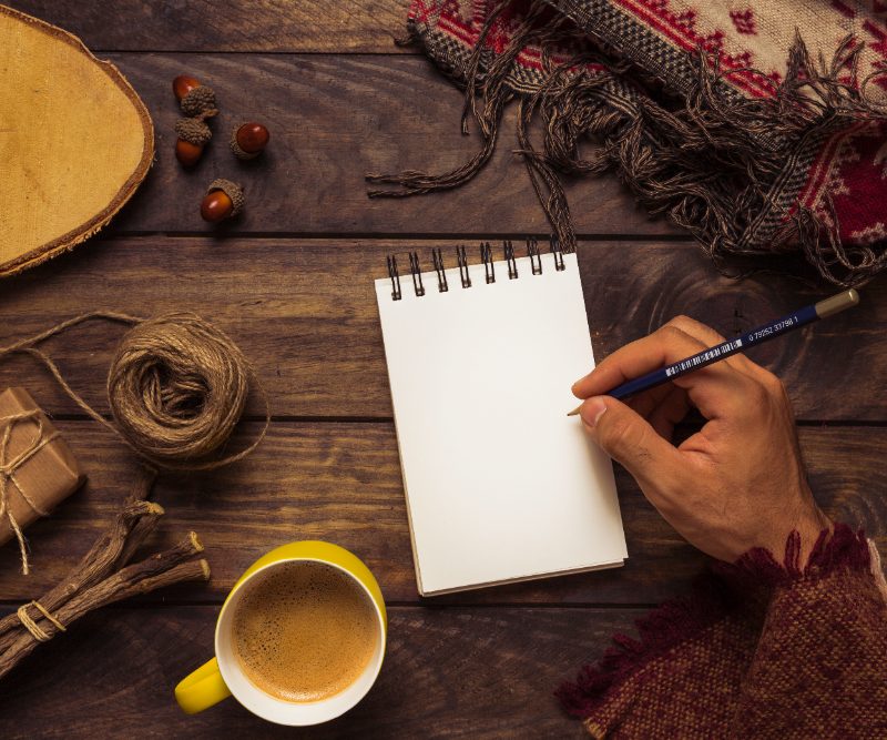 Man with a blank notebook on a table