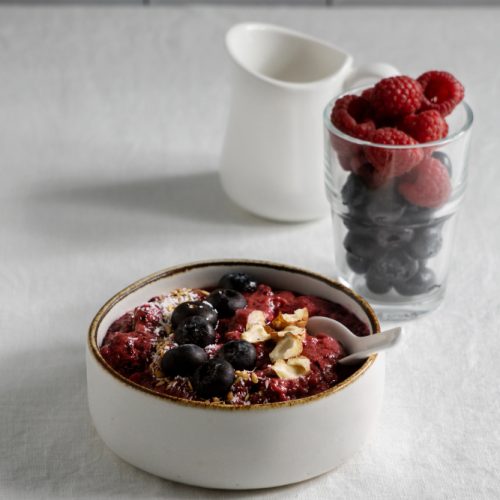 Bowl of oats and fruit on a white counter