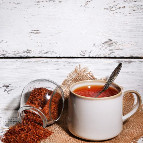 Cup of Rooibos tea on white picnic table