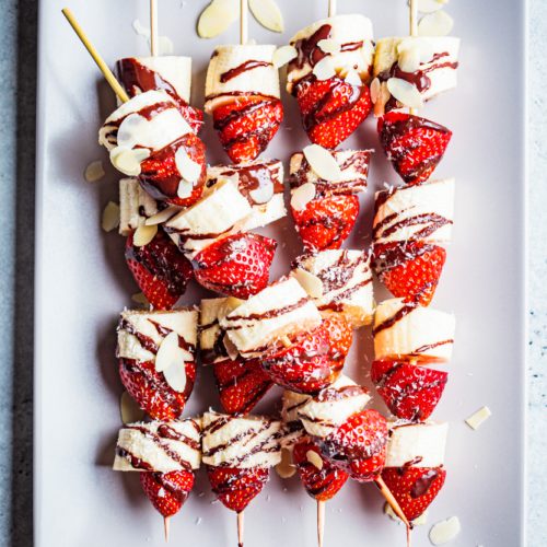Fruit skewers on a white plate