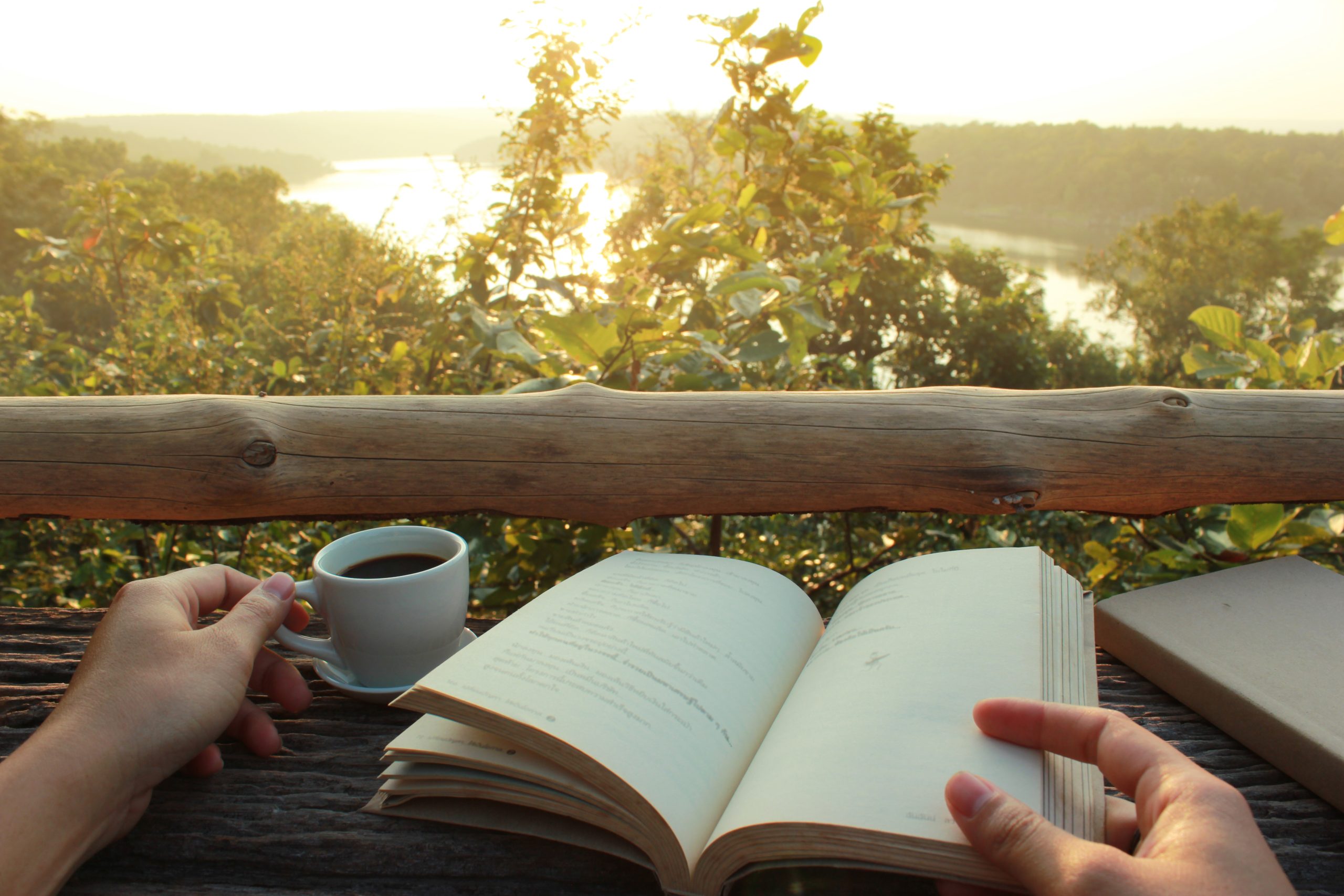 close up of woman's hand with a journal on porch