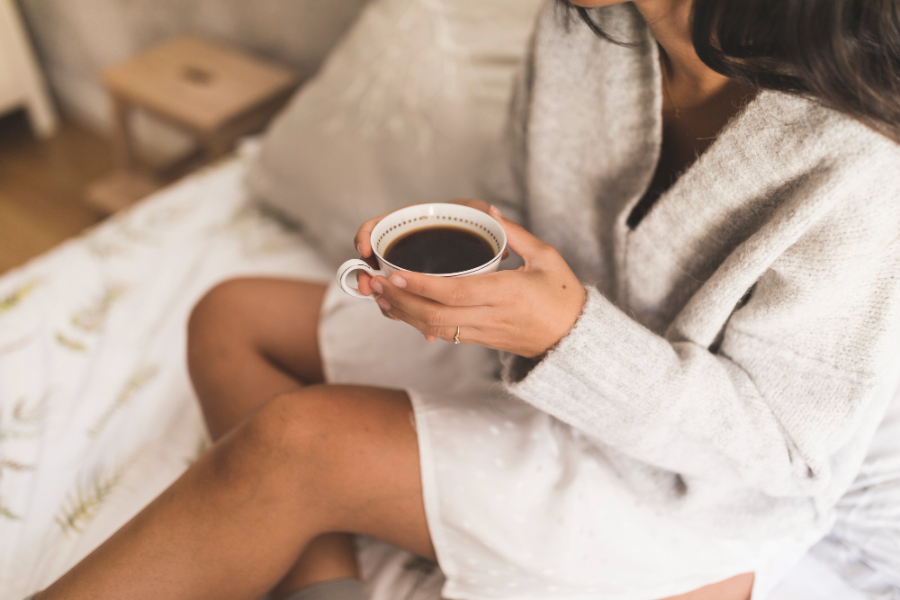 woman in a spa robe with a cup of tea