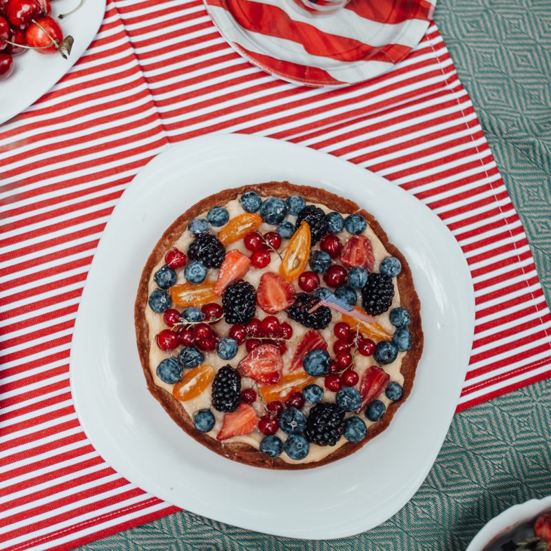 Red, white and blue picnic table with American flag plates and red,white and blue desserts