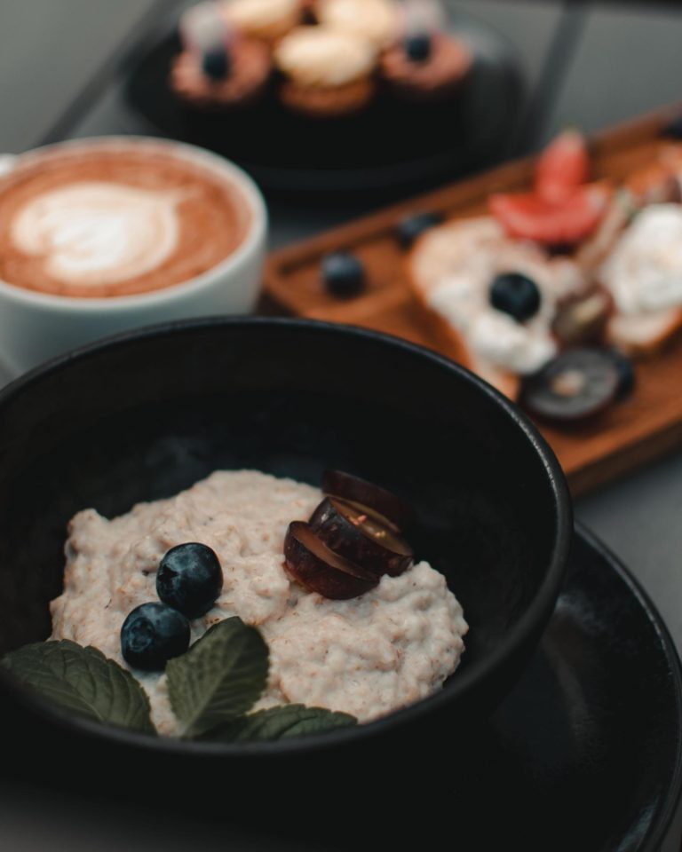 Black bowls with oatmeal and fruit