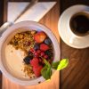 Close up of yogurt with granola, berries and a mint leaf