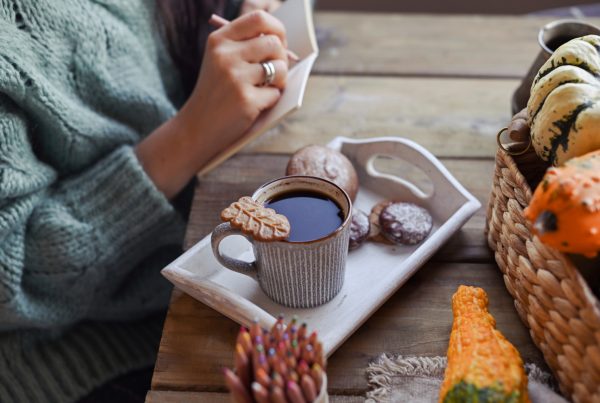 A tray on table with cookie and a cup of Dandy blend