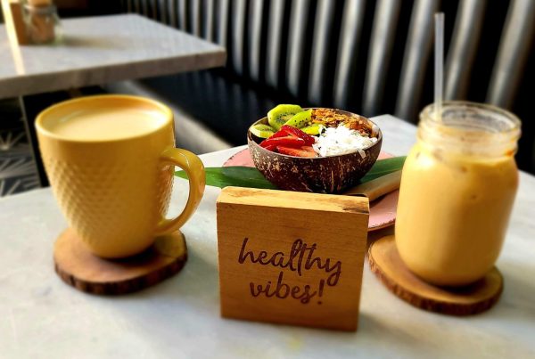 Breakfast with 2 cups, a healthy protein bowl and a sign that says healthy vibes