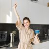 Woman in her kitchen stretching
