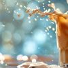 closeup of iced latte splashing when ice is added