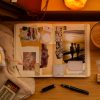 Open journal page on a desk with candles