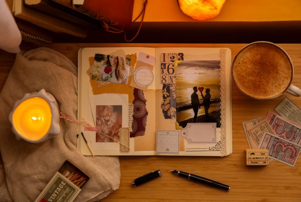 Open journal page on a desk with candles