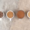 Cups with coffee beans and teas on a table