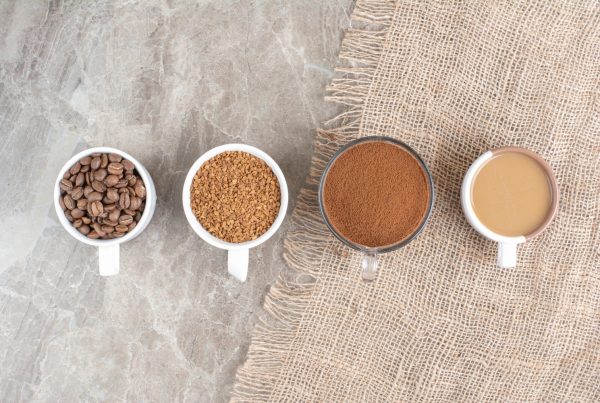 Cups with coffee beans and teas on a table